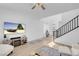 Inviting living space with hardwood floors, a wall-mounted TV, and a contemporary staircase at 272 Mount Steele Ave, Henderson, NV 89015