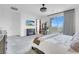 A view of the main bedroom includes a modern ceiling fan, fireplace, and a sliding glass door to a balcony at 272 Mount Steele Ave, Henderson, NV 89015