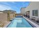 An outdoor pool and spa surrounded by lush landscaping and a privacy wall at 272 Mount Steele Ave, Henderson, NV 89015