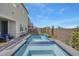 Sparkling pool and spa in a backyard with artificial grass and a privacy wall at 272 Mount Steele Ave, Henderson, NV 89015