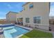 Rear exterior view of a house showing a backyard pool, spa, and exterior elements at 272 Mount Steele Ave, Henderson, NV 89015