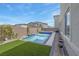 Backyard featuring a pool, spa and artificial grass at 272 Mount Steele Ave, Henderson, NV 89015