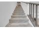 Carpeted stairs leading to the second floor, with gray railing and white walls at 272 Mount Steele Ave, Henderson, NV 89015