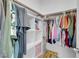 Closet with clothes and storage shelves with pink boxes and yellow pillow at 272 Mount Steele Ave, Henderson, NV 89015