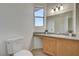 Bright bathroom with window, granite countertop and wooden vanity at 2852 Red Ct, Las Vegas, NV 89123