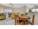 Bright dining area with tile floors, a round wooden table, and a view of the living room and patio at 2852 Red Ct, Las Vegas, NV 89123