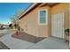 Beige single-story house with desert landscaping and an access gate near the front door at 2852 Red Ct, Las Vegas, NV 89123