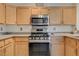 Well-lit kitchen featuring stainless steel appliances and light wood cabinetry at 2852 Red Ct, Las Vegas, NV 89123