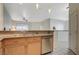 Open kitchen area featuring stainless steel dishwasher and breakfast bar at 2852 Red Ct, Las Vegas, NV 89123
