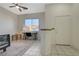 Bright living room space with tiled floors, a work desk, and a white front door at 2852 Red Ct, Las Vegas, NV 89123