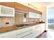 Modern kitchen features stone backsplash, wood cabinets, and stainless steel appliances at 3750 Las Vegas Blvd # 2407, Las Vegas, NV 89158
