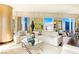 Stylish living room with sleek furniture, a mirrored coffee table, and expansive windows offering city views at 3750 Las Vegas Blvd # 2407, Las Vegas, NV 89158