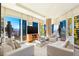 Inviting living room with contemporary seating, TV, and panoramic views through large windows at 3750 Las Vegas Blvd # 2407, Las Vegas, NV 89158