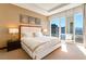 Bright bedroom with a tufted headboard and stunning views through floor-to-ceiling windows at 3750 Las Vegas Blvd # 2407, Las Vegas, NV 89158