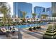 Luxury pool area features lounge chairs, cabanas, palm trees, and city views at 3750 Las Vegas Blvd # 2407, Las Vegas, NV 89158