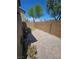This backyard features a brick fence, a small lawn and a paved area at 4256 Perfect Drift St, Las Vegas, NV 89129
