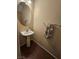 This is a half-bathroom with tile flooring, a sink and decorative towels at 4256 Perfect Drift St, Las Vegas, NV 89129