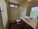 Well-lit bathroom with a single sink vanity, tub-shower combo, and tile flooring at 4256 Perfect Drift St, Las Vegas, NV 89129
