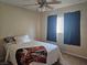 Cozy bedroom with neutral walls, ceiling fan and natural light from two windows at 4256 Perfect Drift St, Las Vegas, NV 89129