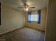 Bright bedroom featuring neutral walls, carpet flooring and a ceiling fan with overhead lighting at 4256 Perfect Drift St, Las Vegas, NV 89129