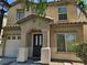 Close up on the front exterior of the home featuring a covered front porch and a two car garage at 4256 Perfect Drift St, Las Vegas, NV 89129