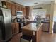 Traditional kitchen with stainless steel appliances and granite countertops, tiled floors and kitchen island at 4256 Perfect Drift St, Las Vegas, NV 89129
