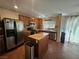 Traditional kitchen features a center island, stainless steel appliances, and tiled flooring at 4256 Perfect Drift St, Las Vegas, NV 89129