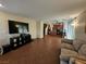 Open-concept living room with tile floors flows into a kitchen at 4256 Perfect Drift St, Las Vegas, NV 89129