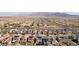 An elevated view shows a thriving neighborhood with solar panels, community amenities, and a mountain backdrop at 4347 Outlook Vista Ave, North Las Vegas, NV 89084