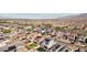 Panoramic aerial shot showcases a community with neatly arranged homes and scenic mountain backdrop at 4347 Outlook Vista Ave, North Las Vegas, NV 89084
