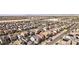 From above, see rows of similar homes with solar panels and desert landscaping, close to amenities and the city at 4347 Outlook Vista Ave, North Las Vegas, NV 89084