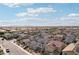 An elevated view reveals a well-planned community with uniform homes set against a sky with fluffy white clouds at 4347 Outlook Vista Ave, North Las Vegas, NV 89084