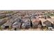 Aerial view of this new community featuring uniform homes, landscaping, garages, and a peek at the surrounding area at 4347 Outlook Vista Ave, North Las Vegas, NV 89084