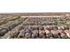 A high-angle shot of a neatly planned community with homes, green spaces, and the cityscape in the distance at 4347 Outlook Vista Ave, North Las Vegas, NV 89084