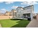 Large backyard with lush artificial grass, a trampoline, and privacy fence at 4347 Outlook Vista Ave, North Las Vegas, NV 89084