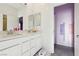 Double sink bathroom with stylish mirrors and access to the nearby bedroom at 4347 Outlook Vista Ave, North Las Vegas, NV 89084