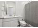 Bathroom with white vanity, neutral color scheme, and shower with patterned curtain at 4347 Outlook Vista Ave, North Las Vegas, NV 89084