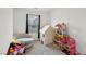 Cozy bedroom featuring a gray chair, play house, and a window view at 4347 Outlook Vista Ave, North Las Vegas, NV 89084