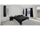 This bedroom features carpet floors, black curtains, and a sliding glass door for natural light at 4347 Outlook Vista Ave, North Las Vegas, NV 89084
