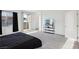 This bedroom features a TV on a shelf and a sliding glass door for natural light at 4347 Outlook Vista Ave, North Las Vegas, NV 89084
