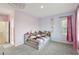 Bright bedroom showcasing a cozy bed, soft carpet, and charming decor at 4347 Outlook Vista Ave, North Las Vegas, NV 89084