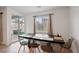 Bright dining area with modern chairs and sliding glass door to backyard at 4347 Outlook Vista Ave, North Las Vegas, NV 89084