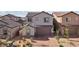Exterior view of a charming home with a brick driveway and attached two-car garage at 4347 Outlook Vista Ave, North Las Vegas, NV 89084