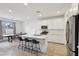 The well-lit kitchen has white cabinets, center island, and stainless steel appliances at 4347 Outlook Vista Ave, North Las Vegas, NV 89084