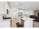 Bright kitchen with white cabinets, stainless steel appliances and large island at 4347 Outlook Vista Ave, North Las Vegas, NV 89084