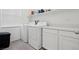 Laundry room featuring modern washer, dryer, and white cabinets at 4347 Outlook Vista Ave, North Las Vegas, NV 89084