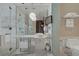 Bright bathroom showcasing dual sinks, a marble countertop, and a glass-enclosed shower with marble walls at 4381 W Flamingo Rd # 27308, Las Vegas, NV 89103