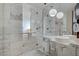 Elegant bathroom featuring a glass shower with double shower heads, a soaking tub, and a marble vanity at 4381 W Flamingo Rd # 27308, Las Vegas, NV 89103