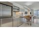 Compact kitchen with stainless steel appliances, modern lighting and breakfast bar with seating at 4381 W Flamingo Rd # 27308, Las Vegas, NV 89103