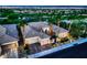 Twilight aerial view of a desert home with well-manicured landscaping, and a three car garage at 4564 Bersaglio St, Las Vegas, NV 89135